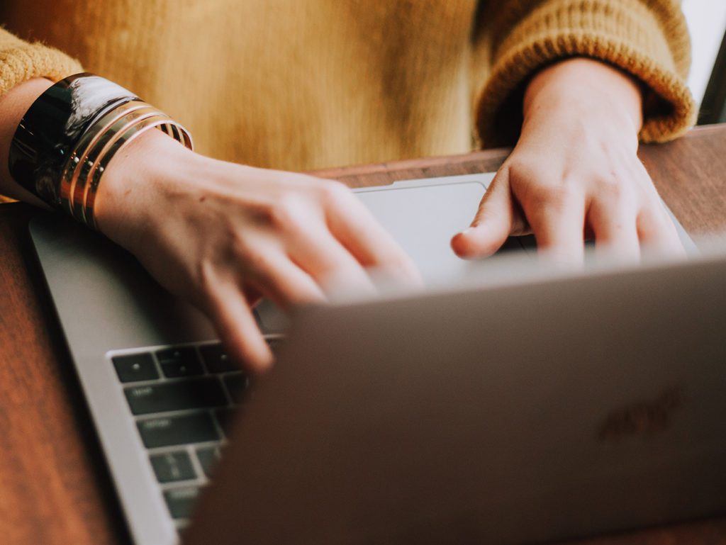 A photo of a woman working on a laptop