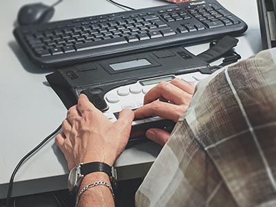Person using assistive technology on their computer.